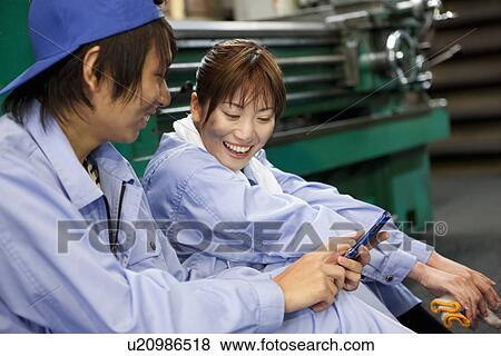 Colleagues Using Mobile Phone View Large Photo Image Stock Photo - Colleagues Using Mobile Phone. Fotosearch