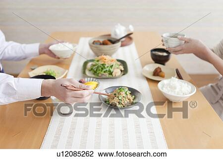 Stock Image - Couple Having Breakfast, Focus on Hands. Fotosearch