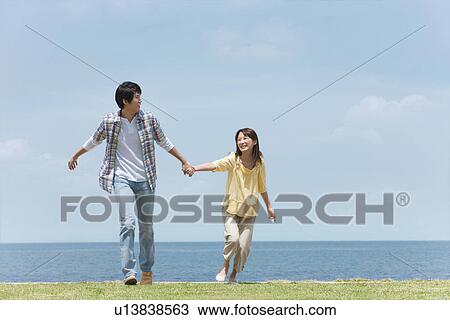 Stock Image - Couple Holding Hands. Fotosearch