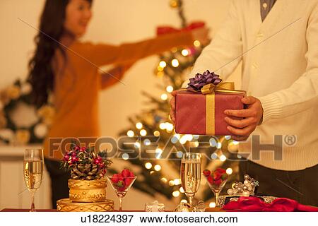 Stock Photo - Couple Preparing Christmas. Fotosearch