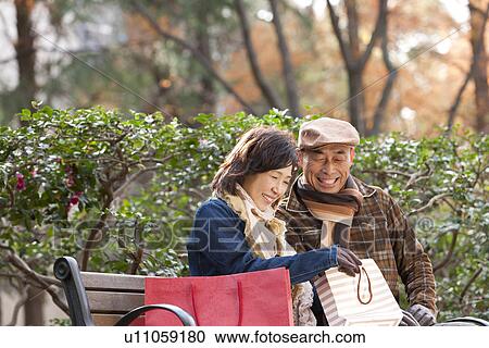 Couple Sitting on a Bench View Large Photo Image Stock Image - Couple Sitting on a Bench. Fotosearch