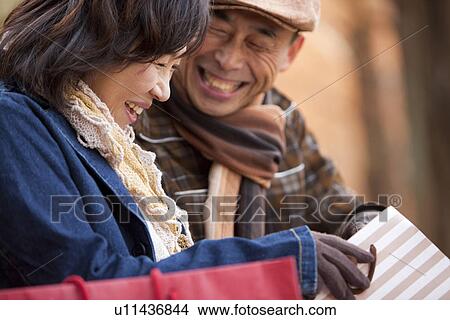 Picture - Couple Sitting Outdoors. Fotosearch