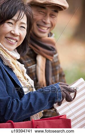 Stock Image - Couple Sitting Outdoors. Fotosearch