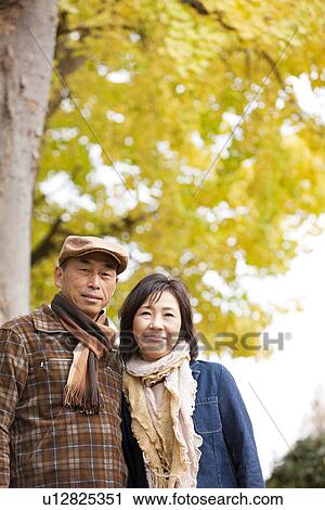 Stock Image - Couple Walking In the Woods In Autumn. Fotosearch
