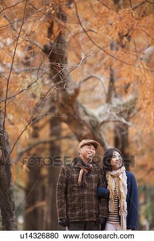 Stock Image - Couple Walking In the Woods In Autumn. Fotosearch