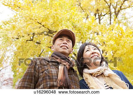 Couple Walking In the Woods In Autumn View Large Photo Image Stock Photo - Couple Walking In the Woods In Autumn. Fotosearch