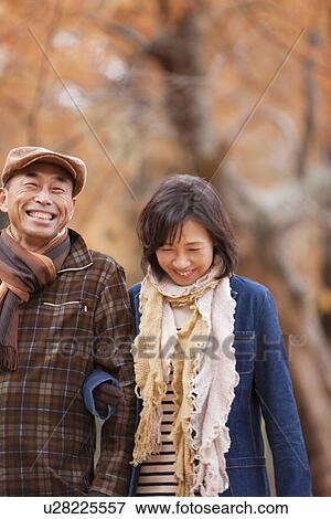 Stock Photo - Couple Walking In the Woods In Autumn. Fotosearch