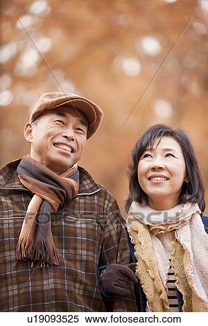Stock Photography - Couple Walking In the Woods In Autumn. Fotosearch