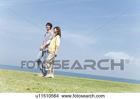 Picture - Couple Walking on Beach. Fotosearch