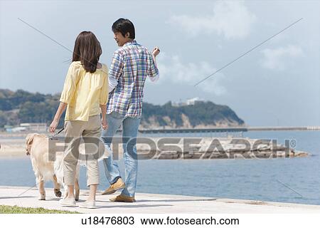 Stock Image - Couple With Dog. Fotosearch