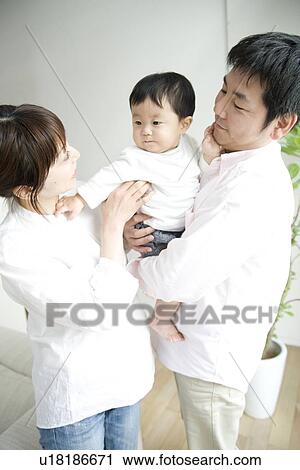 Family in living room View Large Photo Image Stock Image - Family in living room. Fotosearch