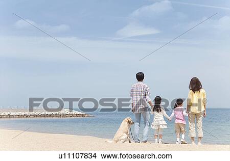 Picture - Family of Four and Dog on Beach. Fotosearch