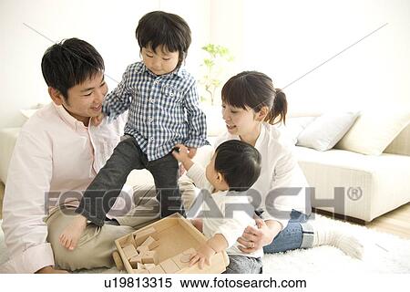 Family of four playing on floor View Large Photo Image Stock Photography - Family of four playing on floor. Fotosearch