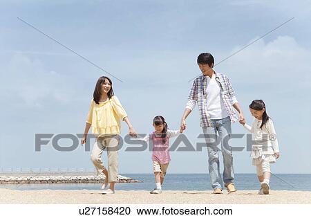 Family of Four Walking In Hand In Hand on Beach View Large Photo Image Stock Image - Family of Four Walking In Hand In Hand on Beach. Fotosearch