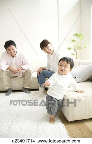 Picture - Family of three in living room. Fotosearch