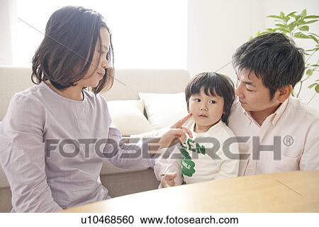 Family of three in living room View Large Photo Image Stock Image - Family of three in living room. Fotosearch