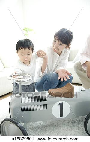 Family playing in living room View Large Photo Image Stock Image - Family playing in living room. Fotosearch