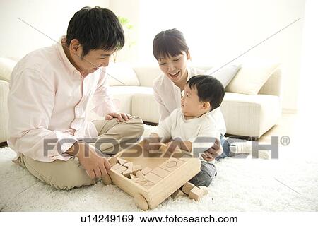 Family playing in living room View Large Photo Image Stock Photo - Family playing in living room. Fotosearch