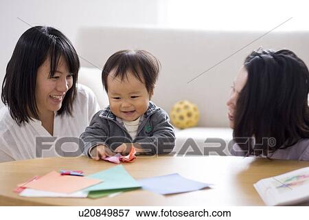 Family playing in living room View Large Photo Image Stock Photo - Family playing in living room. Fotosearch
