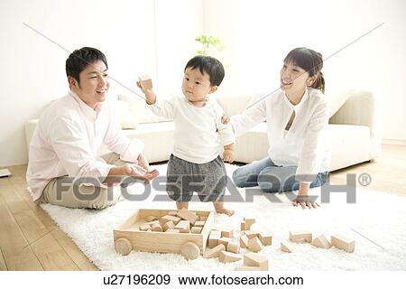 Family playing in living room View Large Photo Image Stock Photo - Family playing in living room. Fotosearch