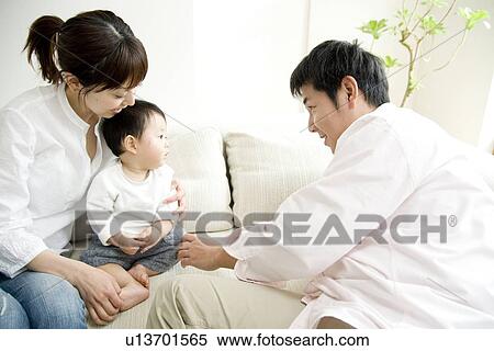 Stock Photography - Family playing in living room. Fotosearch