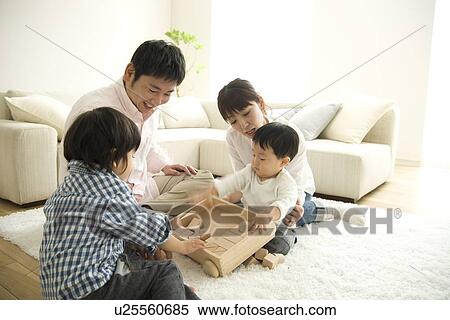 Family playing in living room View Large Photo Image Stock Photography - Family playing in living room. Fotosearch