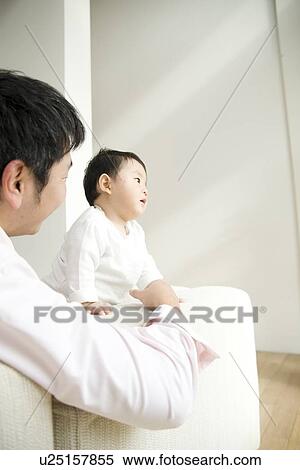 Father and son in living room View Large Photo Image Stock Photography - Father and son in living room. Fotosearch