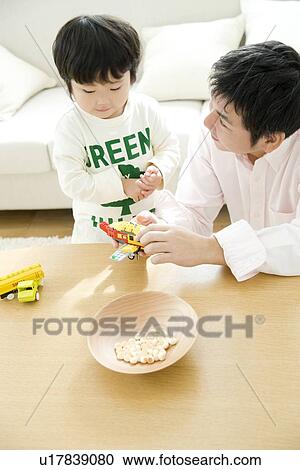 Stock Image - Father and son playing. Fotosearch