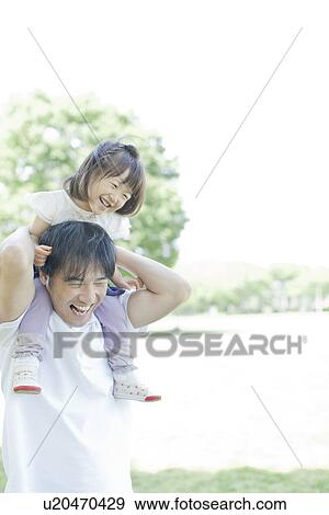 Father carrying daughter on the shoulders View Large Photo Image Stock Photo - Father carrying daughter on the shoulders. Fotosearch