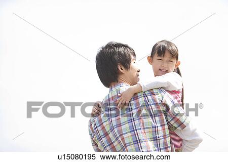 Stock Photography - Father Carrying Daughter. Fotosearch