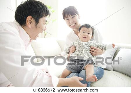 Father tickling son's feet, son sitting on mother's lap View Large Photo Image Stock Image - Father tickling son's feet, son sitting on mother's lap. Fotosearch