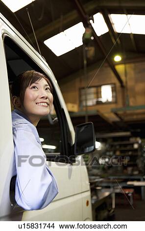 Female Car Mechanic In Car View Large Photo Image Picture - Female Car Mechanic In Car. Fotosearch