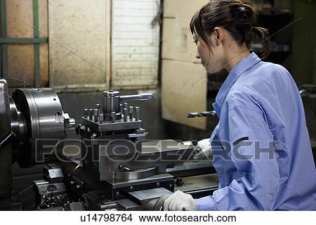 Female Factory Worker Operating Machine View Large Photo Image Picture - Female Factory Worker Operating Machine. Fotosearch