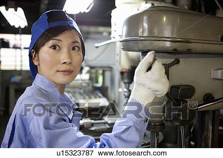 Female Factory Worker Operating Machine View Large Photo Image Stock Photo - Female Factory Worker Operating Machine. Fotosearch