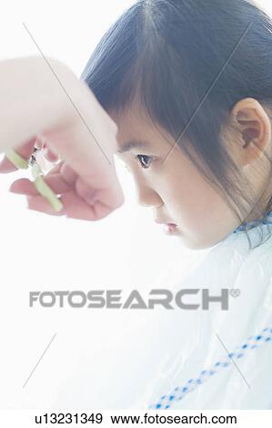 Girl getting a haircut View Large Photo Image Stock Photo - Girl getting a haircut. Fotosearch