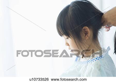 Girl getting a haircut View Large Photo Image Stock Photograph - Girl getting a haircut. Fotosearch