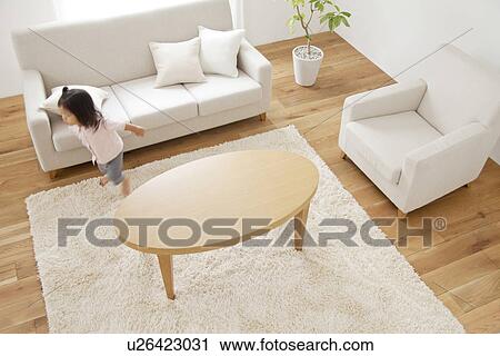Stock Image - Girl in living room. Fotosearch