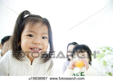 Girl looking at camera, family View Large Photo Image Stock Photo - Girl looking at camera, family. Fotosearch