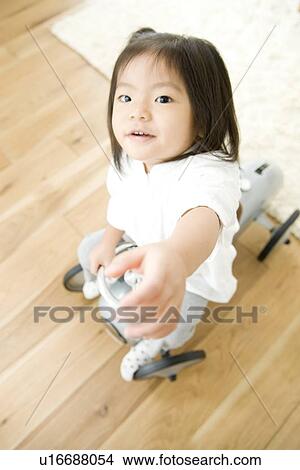 Picture - Girl playing with toy car. Fotosearch