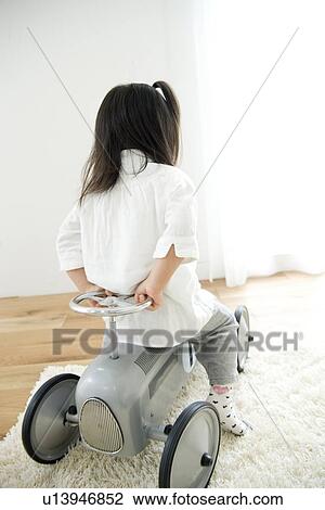 Girl playing with toy car View Large Photo Image Stock Image - Girl playing with toy car. Fotosearch