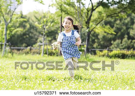Stock Image - Girl Running In Field. Fotosearch
