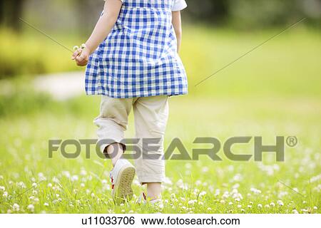 Stock Photograph - Girl Walking on Grass. Fotosearch
