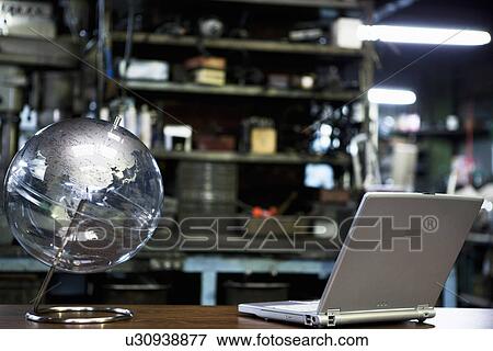 Globe and Laptop In Factory View Large Photo Image Stock Photo - Globe and Laptop In Factory. Fotosearch