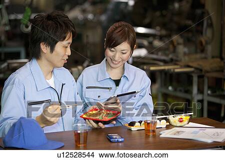 Picture - Male and Female Worker Having Lunch Break. Fotosearch