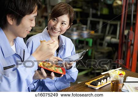 Stock Photo - Male and Female Worker Having Lunch Break. Fotosearch