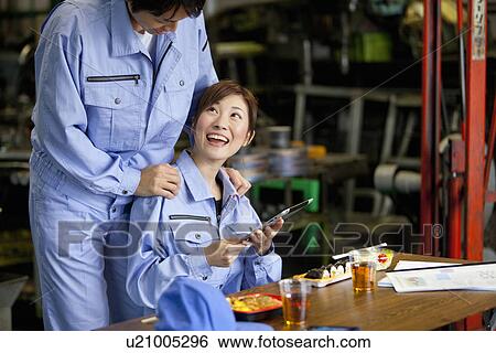 Stock Photograph - Male and Female Worker Having Lunch Break. Fotosearch