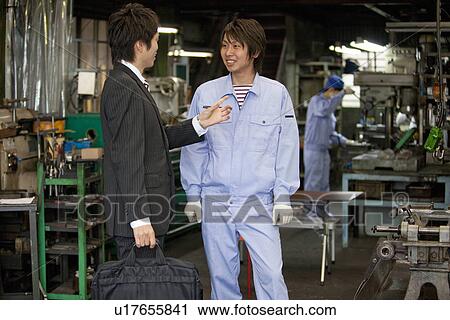 Stock Image - Male Worker Talking to Boss. Fotosearch