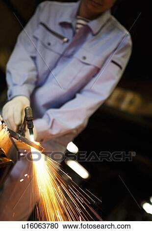 Stock Image - Male Worker Welding. Fotosearch