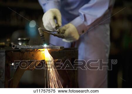 Stock Photography - Male Worker Welding. Fotosearch