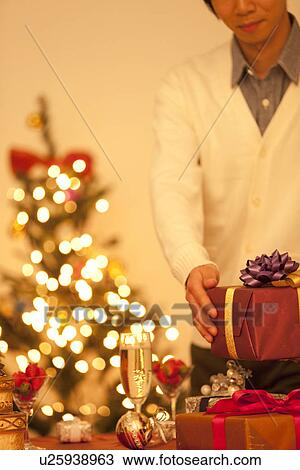Man Putting Down Christmas Present View Large Photo Image Stock Image - Man Putting Down Christmas Present. Fotosearch